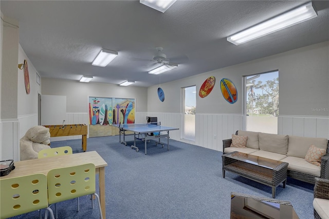 game room with ceiling fan, carpet floors, and a textured ceiling