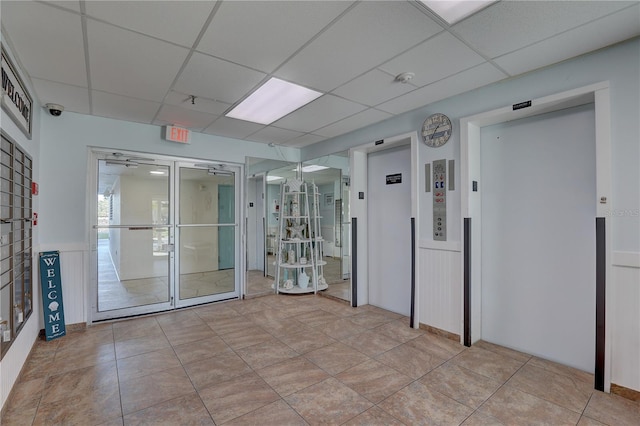 tiled spare room with elevator and a drop ceiling