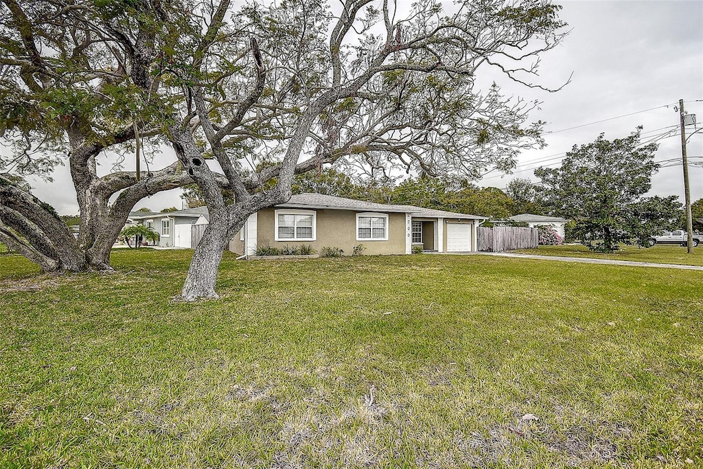 view of front of home with a front lawn and a garage