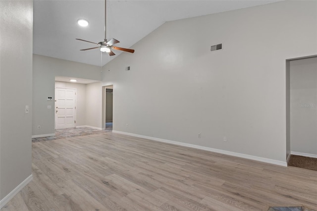 spare room featuring ceiling fan, high vaulted ceiling, and light wood-type flooring