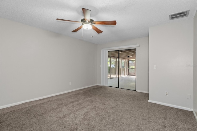 spare room with carpet flooring, ceiling fan, and a textured ceiling