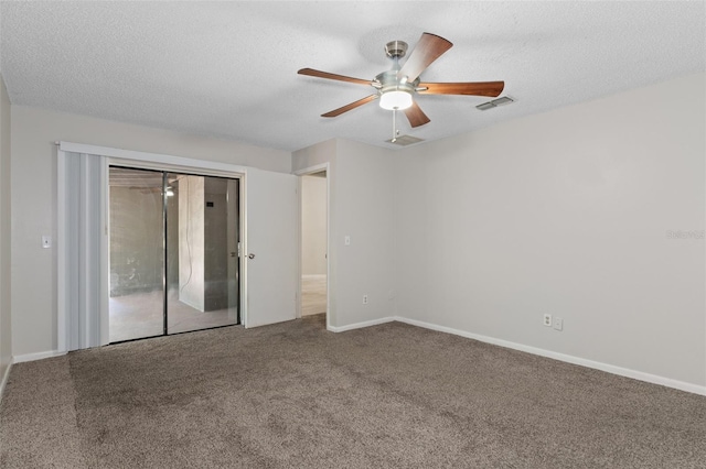 spare room with carpet, ceiling fan, and a textured ceiling