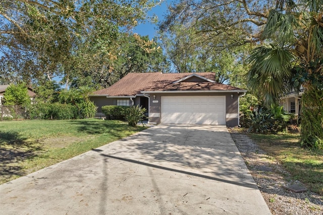 view of front of home with a front lawn and a garage