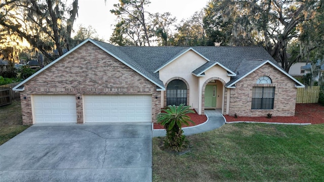 single story home with a front yard and a garage