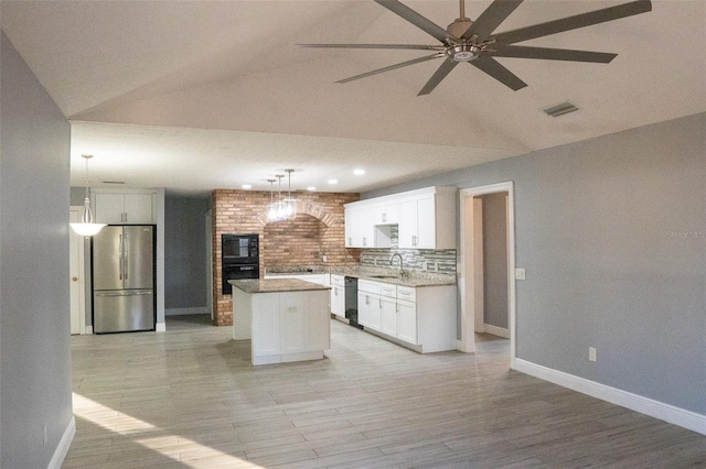 kitchen with vaulted ceiling, black appliances, pendant lighting, white cabinets, and a kitchen island