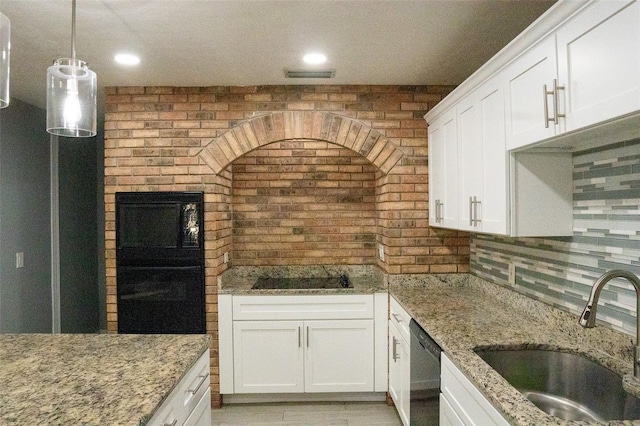 kitchen featuring white cabinets, light stone countertops, black appliances, and sink