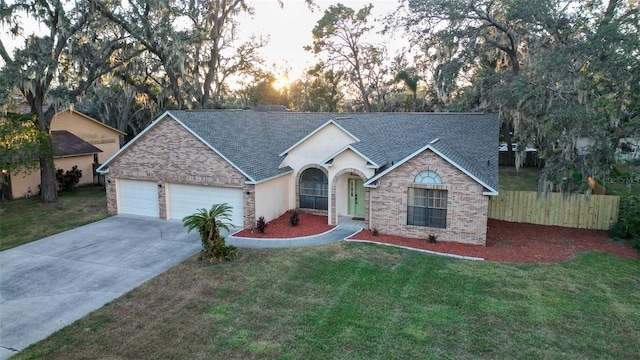 ranch-style house with a yard and a garage