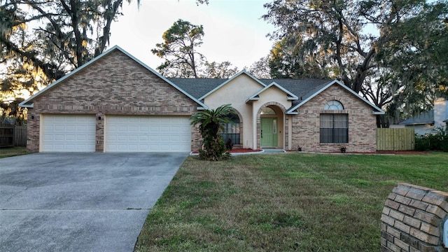 ranch-style home with a front yard and a garage