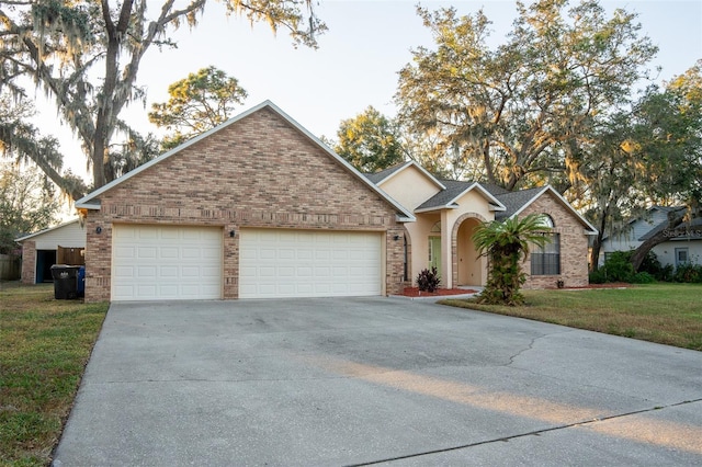 single story home with a front lawn and a garage