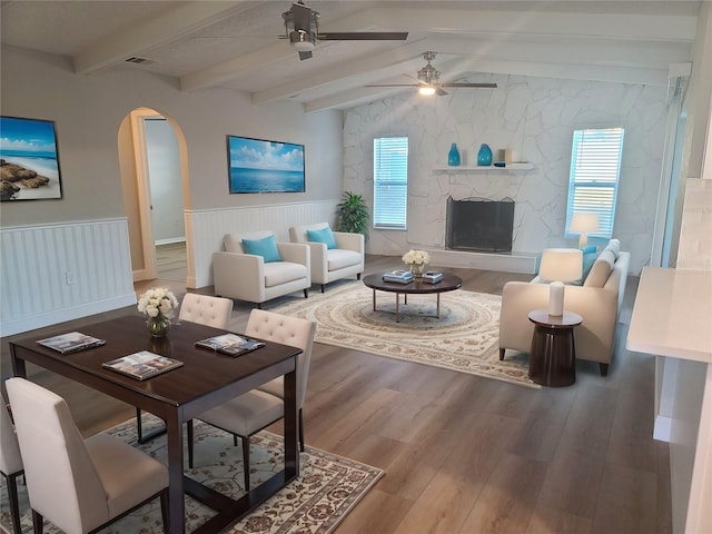 living room featuring vaulted ceiling with beams, ceiling fan, and hardwood / wood-style flooring