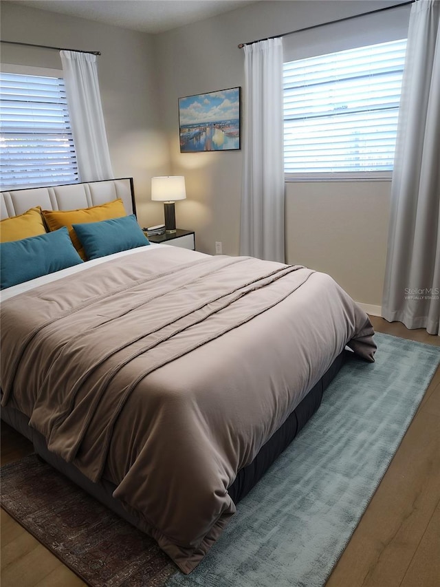 bedroom with hardwood / wood-style flooring