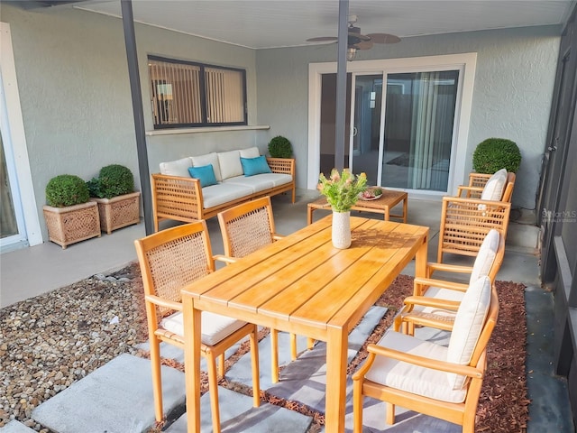 view of patio with an outdoor living space and ceiling fan