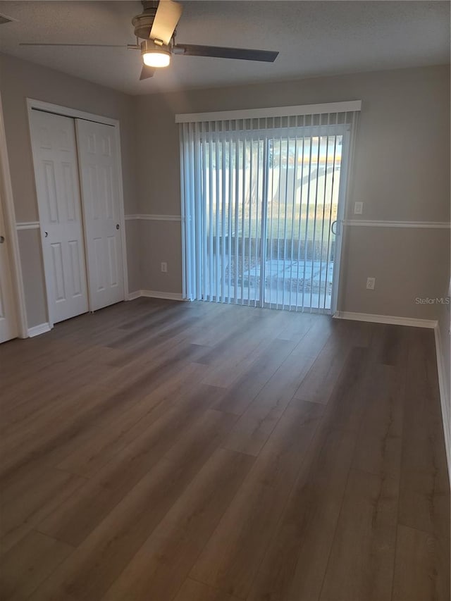 unfurnished room with ceiling fan and wood-type flooring