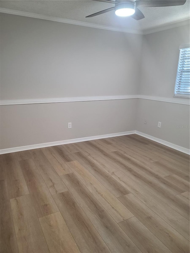 empty room with ceiling fan, light hardwood / wood-style floors, ornamental molding, and a textured ceiling