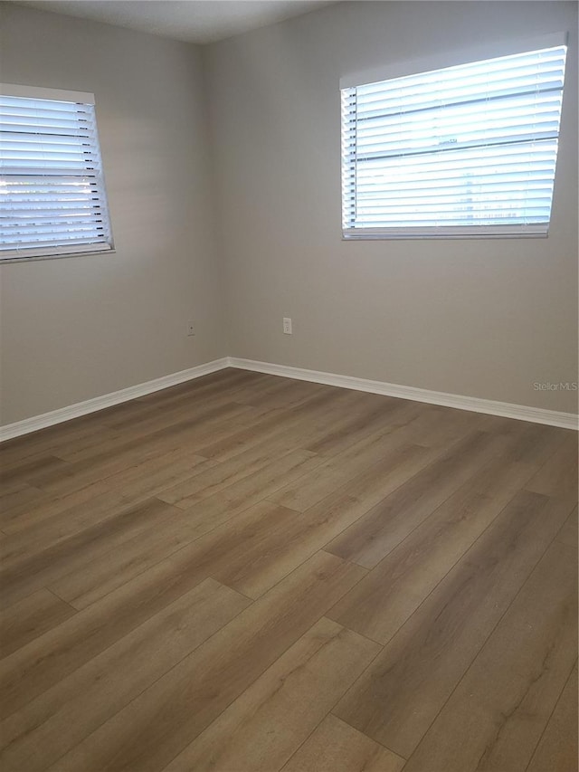 empty room with hardwood / wood-style flooring