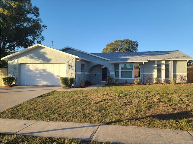 single story home with a garage and a front yard