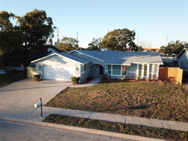 ranch-style home featuring a front yard and a garage