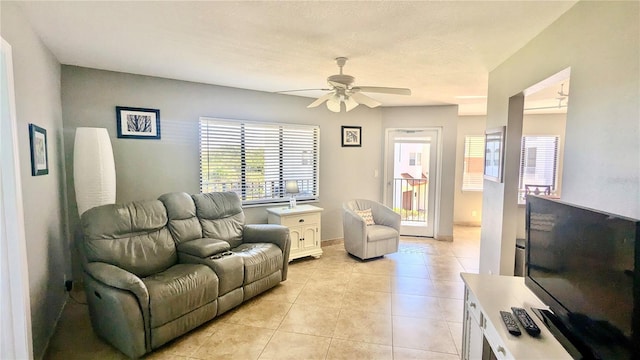 living room with ceiling fan and light tile patterned flooring