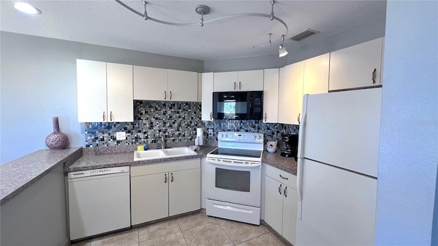 kitchen with white appliances, white cabinets, sink, decorative backsplash, and a textured ceiling