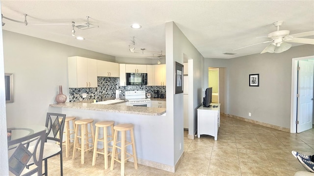 kitchen featuring white cabinetry, white electric stove, kitchen peninsula, a textured ceiling, and decorative backsplash