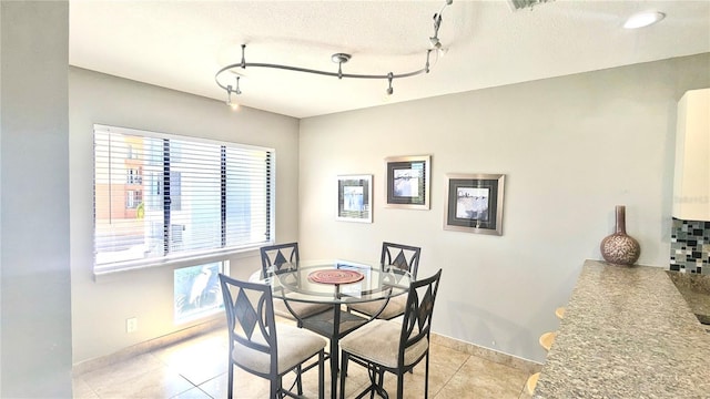 1515 Pinellas Bayway S Unit 35, Tierra Verde, FL 33715 - dining space with light tile patterned flooring, track lighting, and baseboards