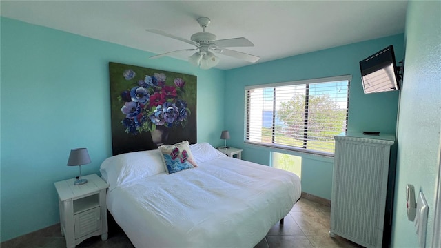 bedroom featuring light tile patterned floors and ceiling fan