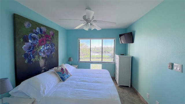 bedroom with ceiling fan and light tile patterned floors