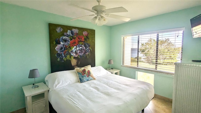 1515 Pinellas Bayway S Unit 35, Tierra Verde, FL 33715 - bedroom featuring tile patterned flooring, a ceiling fan, and baseboards