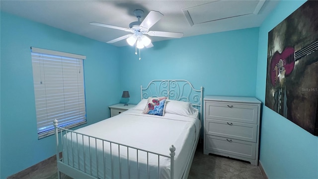 bedroom with ceiling fan and dark tile patterned floors