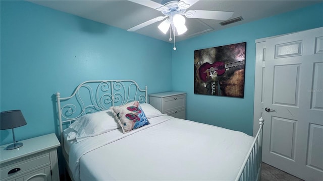 tiled bedroom with ceiling fan