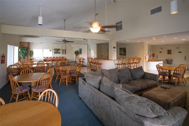 living room featuring ceiling fan and high vaulted ceiling