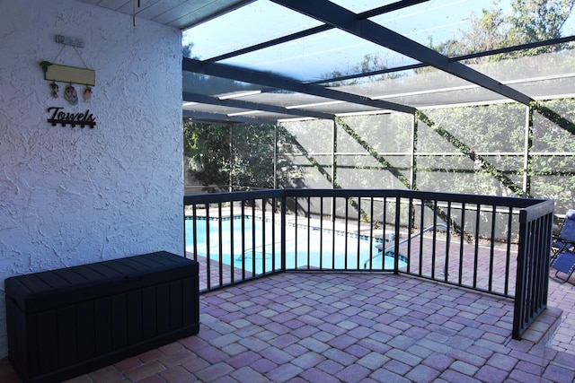 view of patio / terrace featuring glass enclosure