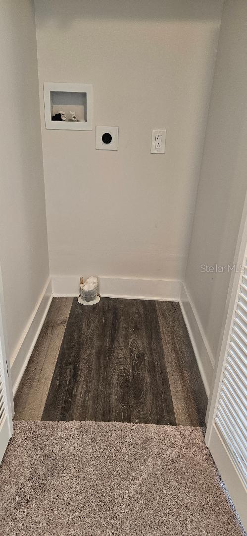 clothes washing area with dark wood-type flooring, washer hookup, and electric dryer hookup