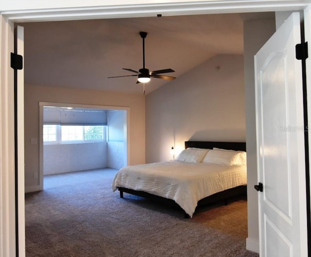 bedroom with ceiling fan, carpet, and lofted ceiling