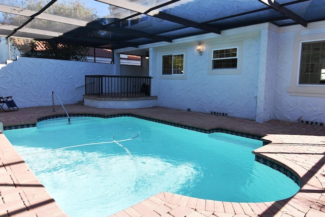 view of swimming pool with a lanai and a patio