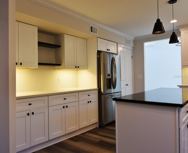 kitchen featuring pendant lighting, stainless steel refrigerator with ice dispenser, crown molding, white cabinetry, and dark wood-type flooring