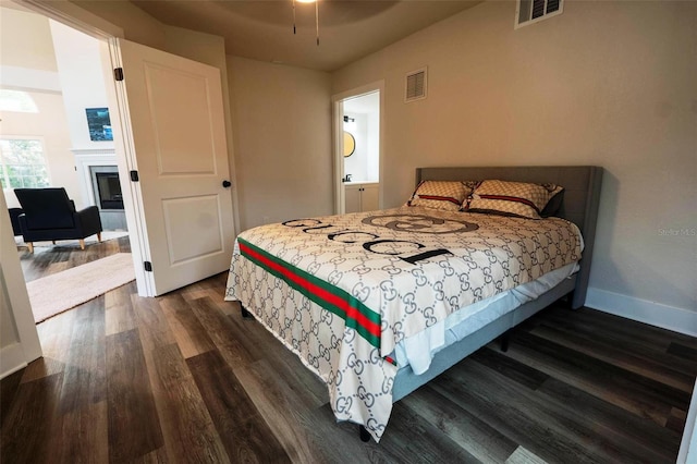 bedroom with dark hardwood / wood-style flooring