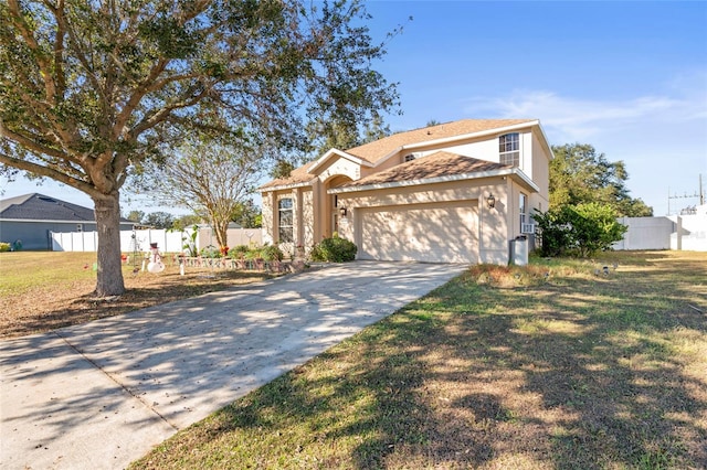 view of property featuring a front lawn and a garage