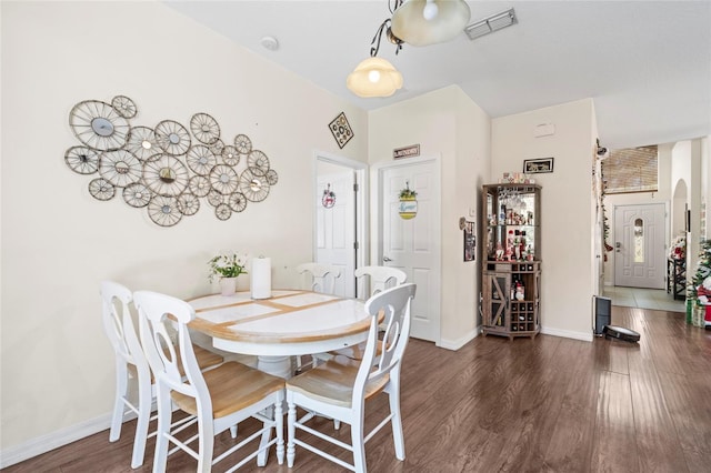 dining area with dark hardwood / wood-style floors