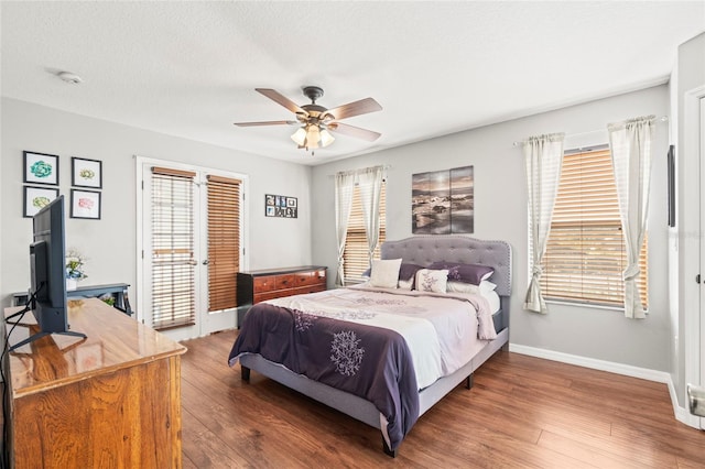 bedroom featuring a textured ceiling, access to outside, ceiling fan, and dark wood-type flooring