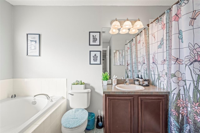 full bath featuring tiled tub, vanity, and toilet