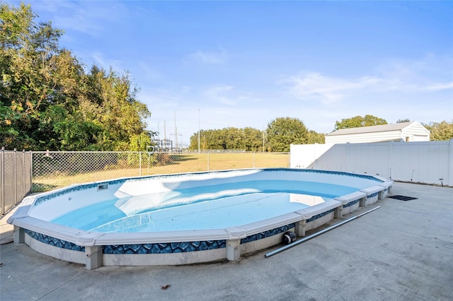 view of swimming pool with fence