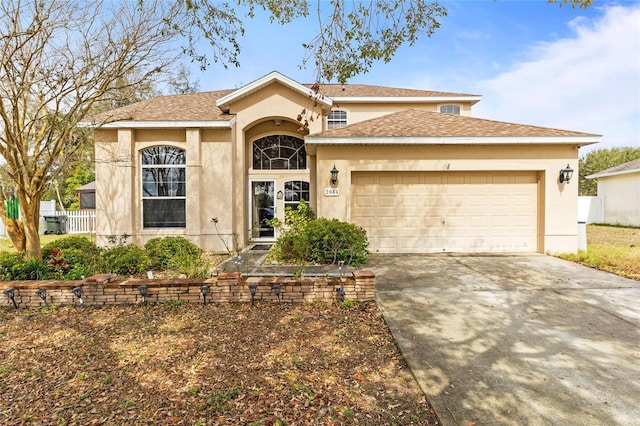 view of front of house with a garage, concrete driveway, and stucco siding