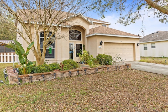 view of front facade featuring driveway, a garage, and stucco siding