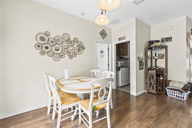 dining area with baseboards, visible vents, washer / clothes dryer, and dark wood-style flooring