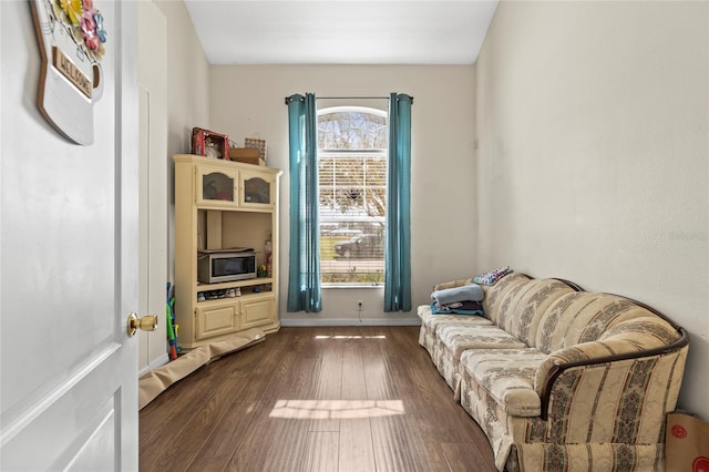 living area with dark wood finished floors and baseboards