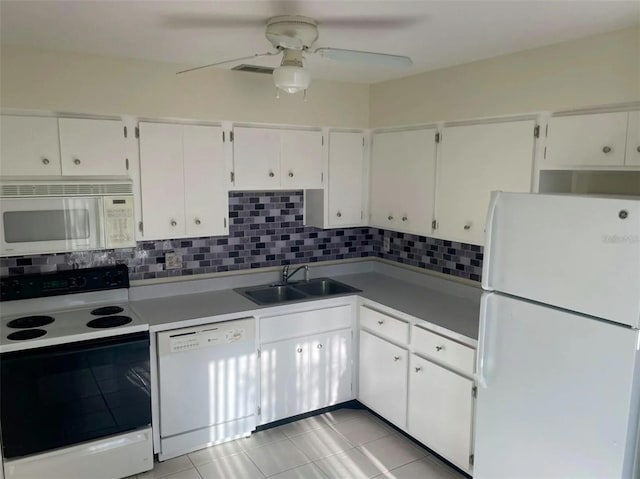 kitchen featuring decorative backsplash, white appliances, white cabinetry, and sink