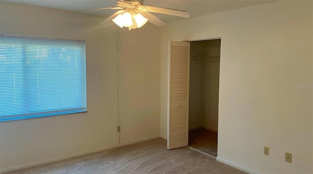 unfurnished bedroom with ceiling fan, a closet, and light colored carpet