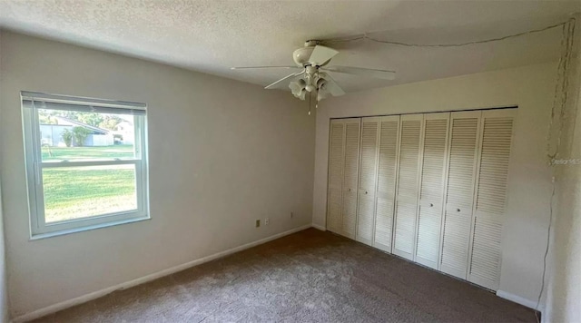 unfurnished bedroom with ceiling fan, a closet, carpet, and a textured ceiling