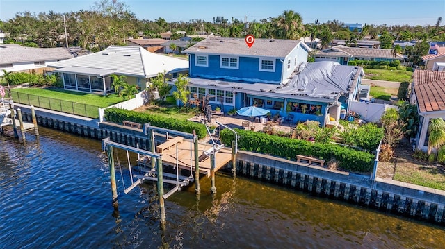 back of house with a yard and a water view